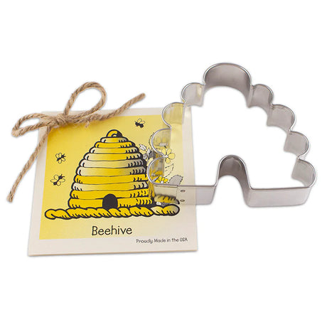 Metallic bee hive cookie cutter with packaging featuring a yellow bee hive illustration on a white background.
