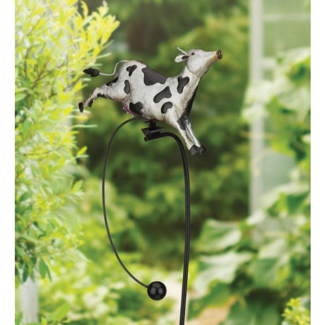 Metal garden stake with solar-powered flower light among garden plants