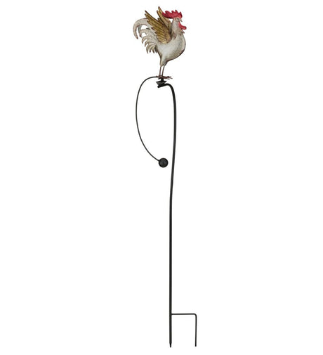 the whole photo of A metal garden stake featuring a colorful rooster with detailed feathers, perched on a rocker that moves in the wind.