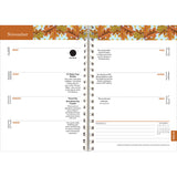 Interior page of the Old Farmer's Almanac planner showing the November 9-15 weekly planner page spread noting moon phases, holidays, with autumnal orange and yellow oak leaves illustration at the top of the pages