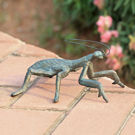 charming cast iron praying mantis sculpture outdoors on a garden patio