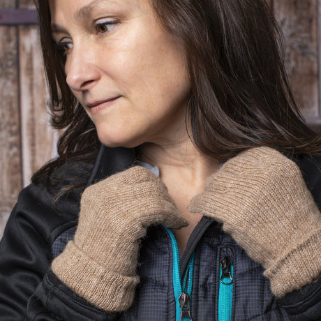 a model wearing the camel gloves adjusts her collar