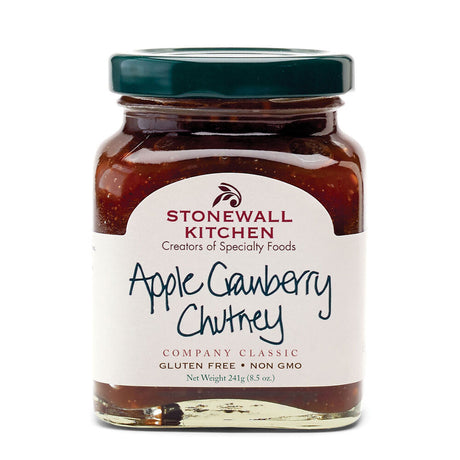 a jar of apple cranberry chutney against a white background