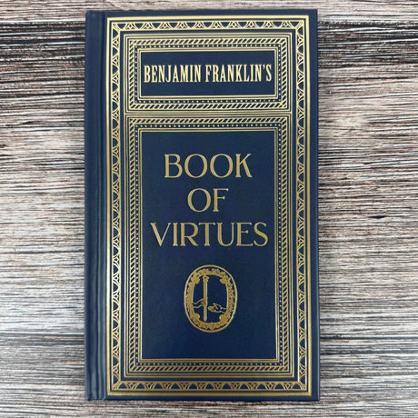 Book titled 'Benjamin Franklin's Book of Virtues' on a wooden surface