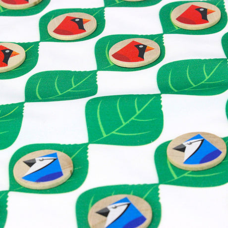 a close up of the fabric checkerboard with green leaf squares and cardinal and blue jay checkers