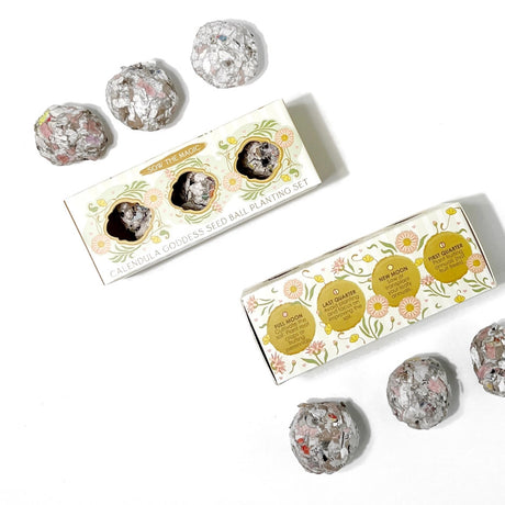 two sets of the calendula goddess seed ball set with whimsical packaging and seed balls