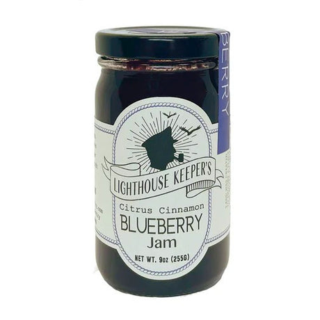a jar of blueberry jam with a white label with a logo of a silhoutted man in a captain's hat smoking a pipe with seagulls flying behind him