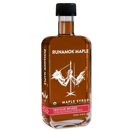 A bottle of festivus infused maple syrup against a white background