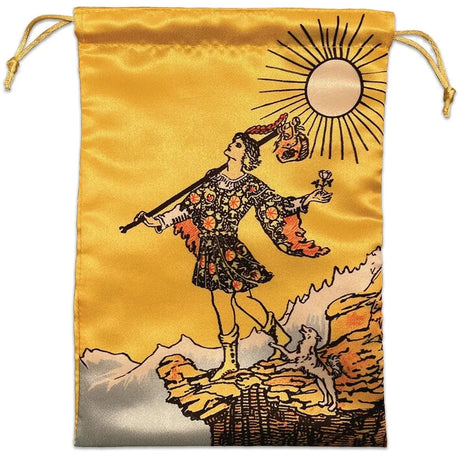 vibrant golden yellow drawstring pouch laid flat with the illustration from the Fool tarot card on it:  a man in ornate clothes with a stick and bindle in one hand, rose in the other, walks blissfully unaware towards a cliff's edge while a small