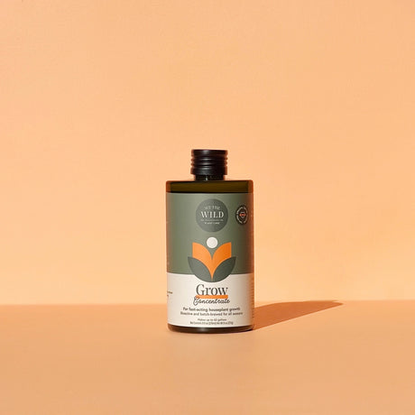 a bottle of the grow concentrate against an orange background