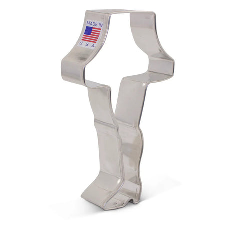 a tin cookie cutter in the shape of a leg in high heels topped with a lampshade