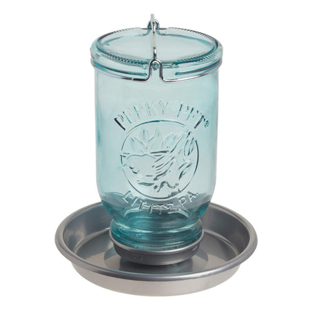 a blue glass style mason jar bird waterer with round steel basin for birds to perch and drink