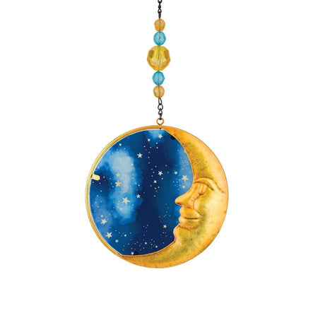 a circular suncatcher with a friendly yellow crescent moon face against a blue sky background with stars with gold and blue beads on the suncatcher's chain