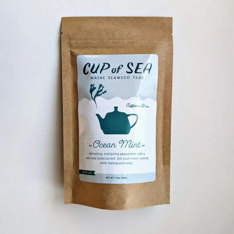 a kraft tea package with a white and blue label that reads "Cup of Sea - Maine Seaweed Teas - Ocean Mint" with a graphic of a solid blue tea kettle with seaweed shaped steam rising out of the spout