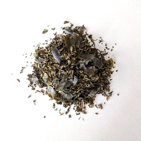 a small mound of loose leaf Ocean Mint tea showing the seaweed and mint blend