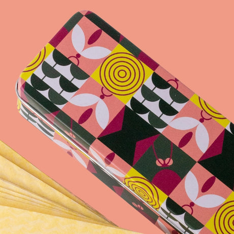 the pest trap container tin design detail showing playful minimal graphics of winged pests and plant leaves alongside fanned pest traps