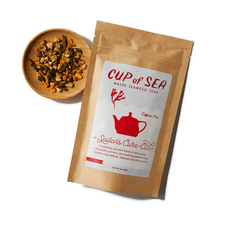 a kraft tea package with a white and red label that reads "Cup of Sea - Maine Seaweed Teas - Sailor's Cure-All" with a graphic of a solid red tea kettle with seaweed shaped steam rising out of the spout next to a small round bowl filled with loose leaf tea