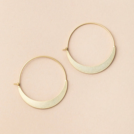 a pair of gold hoop earrings that take the shape of a crescent moon