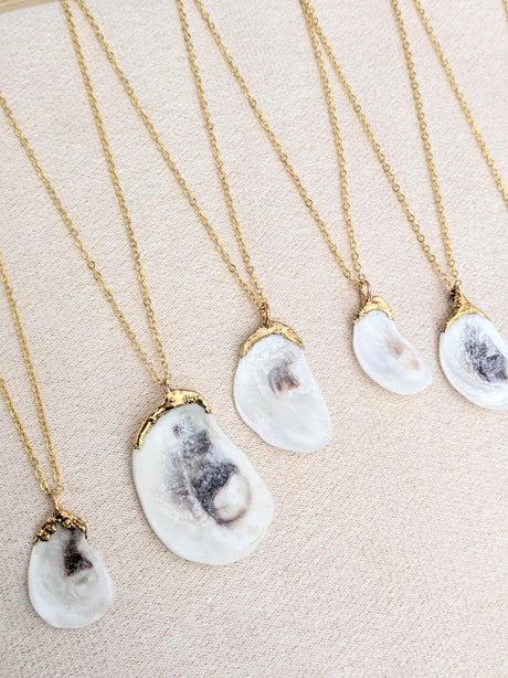 a grouping of 5 Oyster Shell necklaces to show the variation in shell size as well as unique qualities that occur with every shell