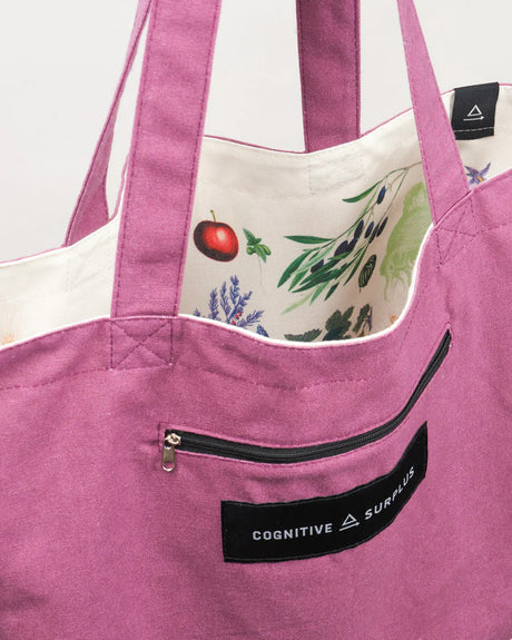 a close up of the tote near the handles showing the bag reversed so the fruit and veggie print is on the inside of the tote and the outside is now a warm lavender