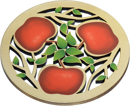 a round trivet with laser cut apple and branch design with red painted apples and green leaves