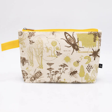 a white canvas zipper pouch with vintage illustrations and scientific diagrams of honey bees. the pouch has a yellow strap for easy carrying