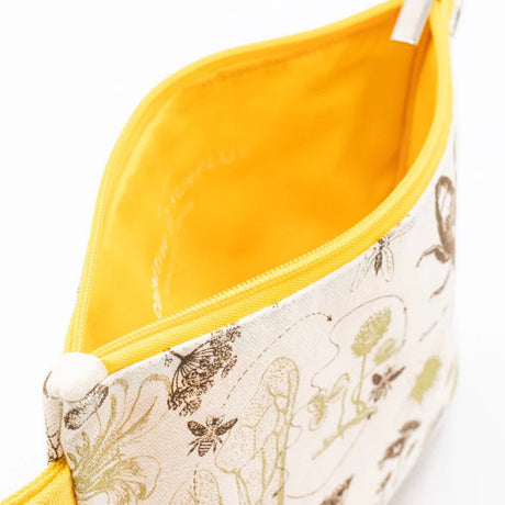 a close up of the honey bee zipper pouch showing the pouch unzipped revealing the solid yellow lining